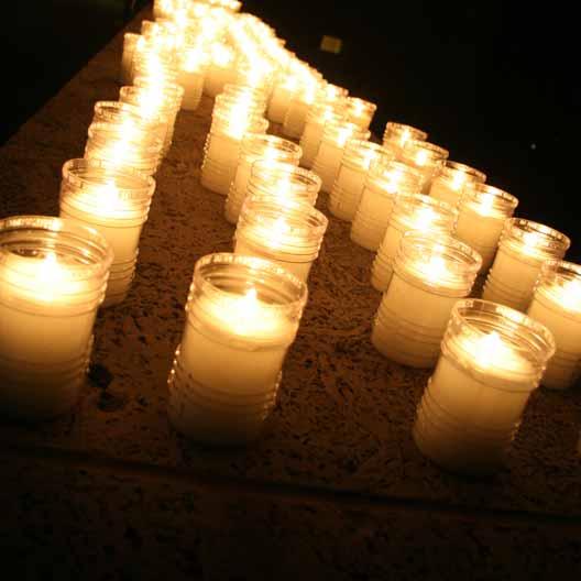 Lit candles for Mary's Grotto spread across the floor